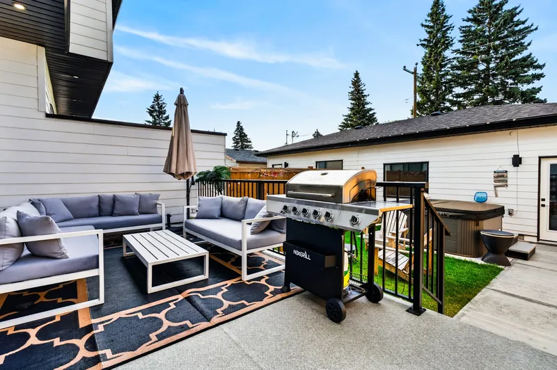 Backyard patio with seating and hot tub